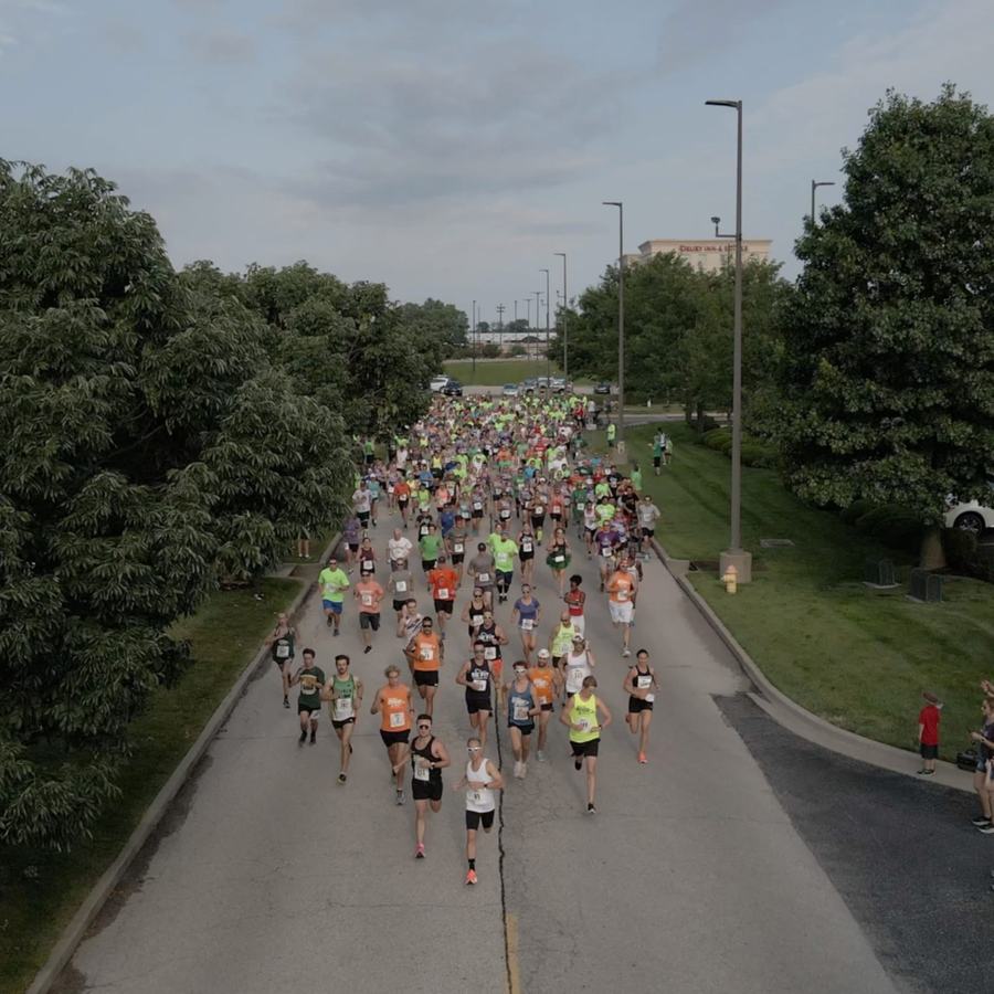 Runners filling the road at the start of a race