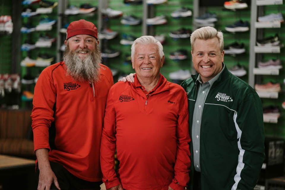The Toolen family in the store, in front of a wall of running shoes