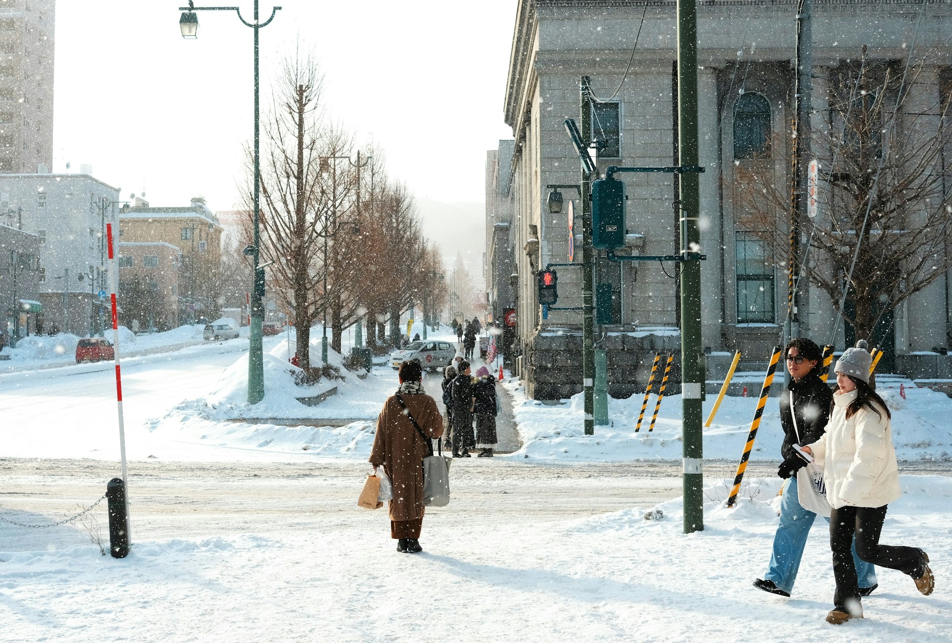 Group of people walking together on a snow-covered street