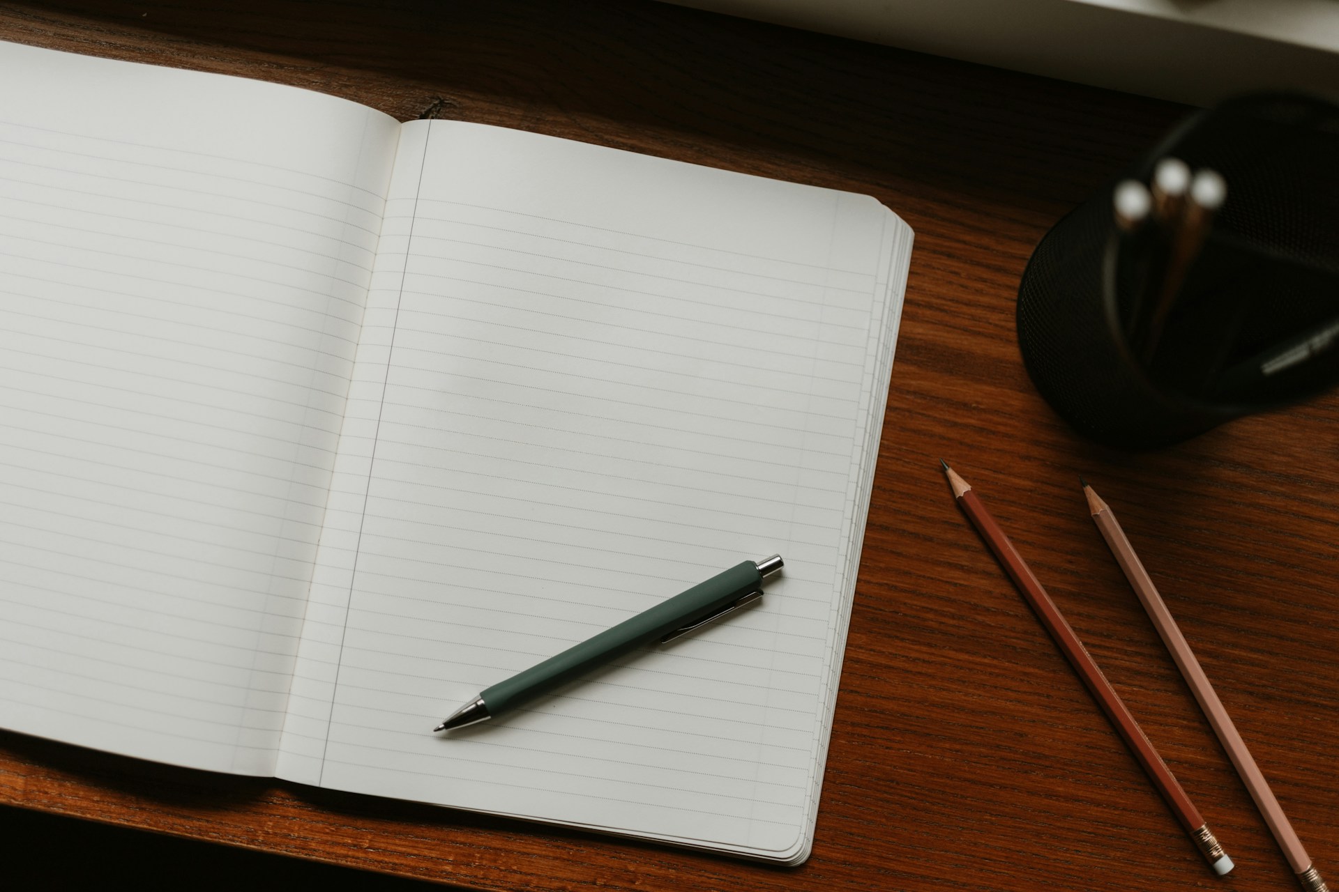 Open notebook with pen on a desk, ready for writing down a SMART running goal