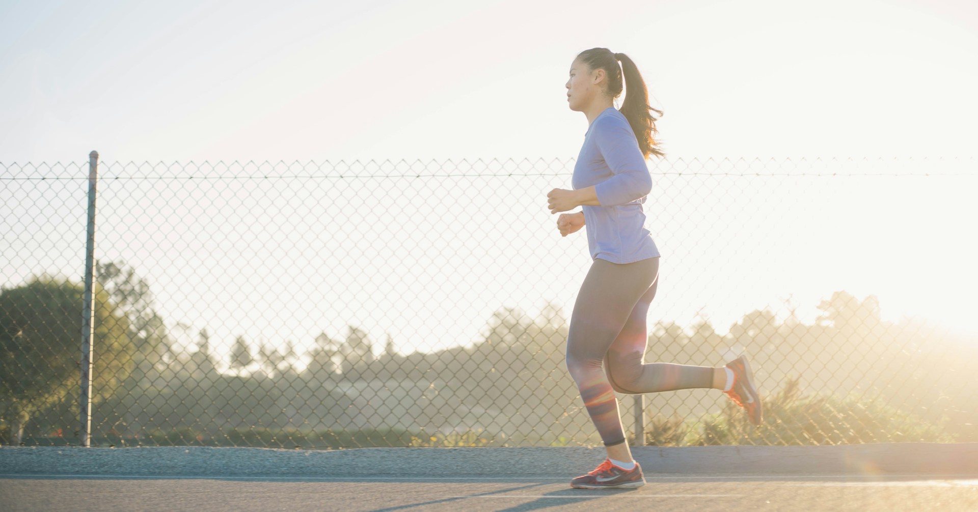 Woman jogging at an easy pace on a paved path